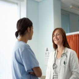 Two people, nurse and doctor in discussion